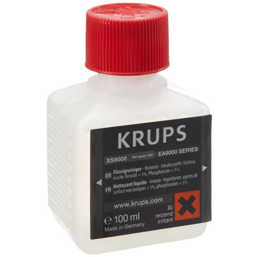Eine Flasche mit rotem Deckel. Aufkleber mit Produktinformationen und KRUPS-Logo. Weiße Flüssigkeit sichtbar.