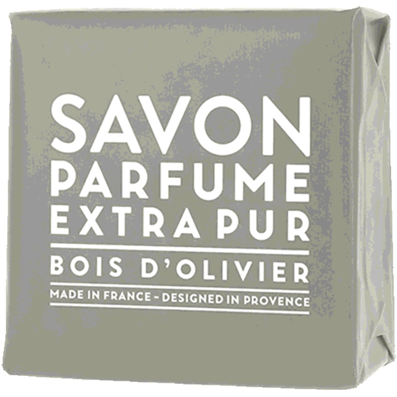 Graues Seifenstück in Papier verpackt. Text: Savon Parfume Extra Pur Bois d'Olivier. Hergestellt in Frankreich, entworfen in der Provence.