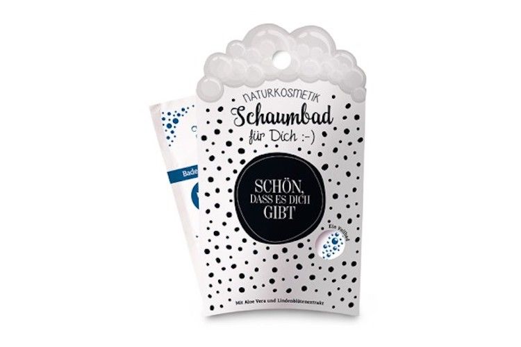 Confezione di bagnoschiuma. Punti neri su sfondo bianco. Testo: Naturkosmetik, Schaumbad für Dich. Cerchio nero con testo: Schön, dass es Dich gibt.