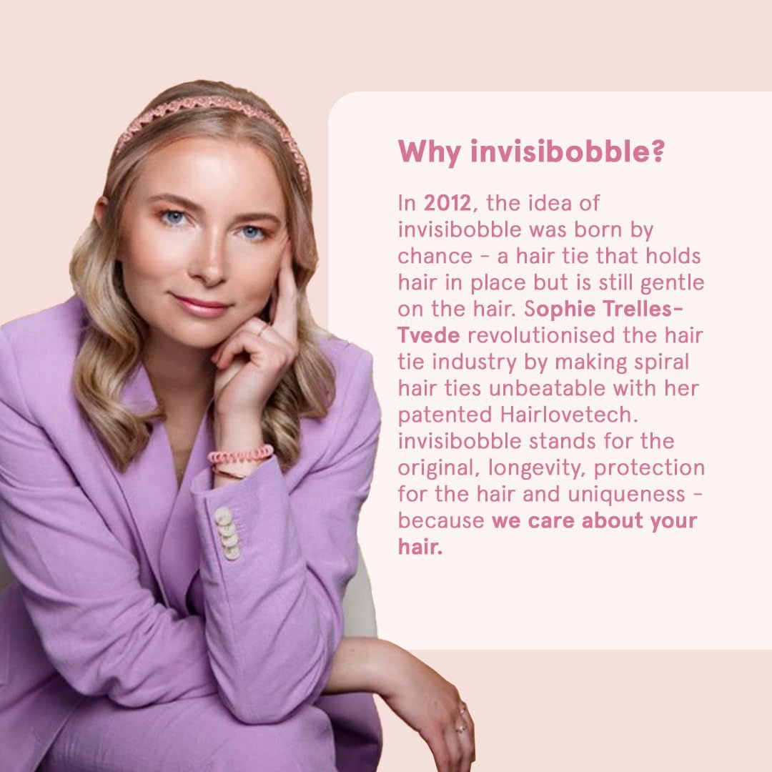 Frau mit rosa Blazer und Haargummi. Text über die Marke Invisibobble und ihre Geschichte.