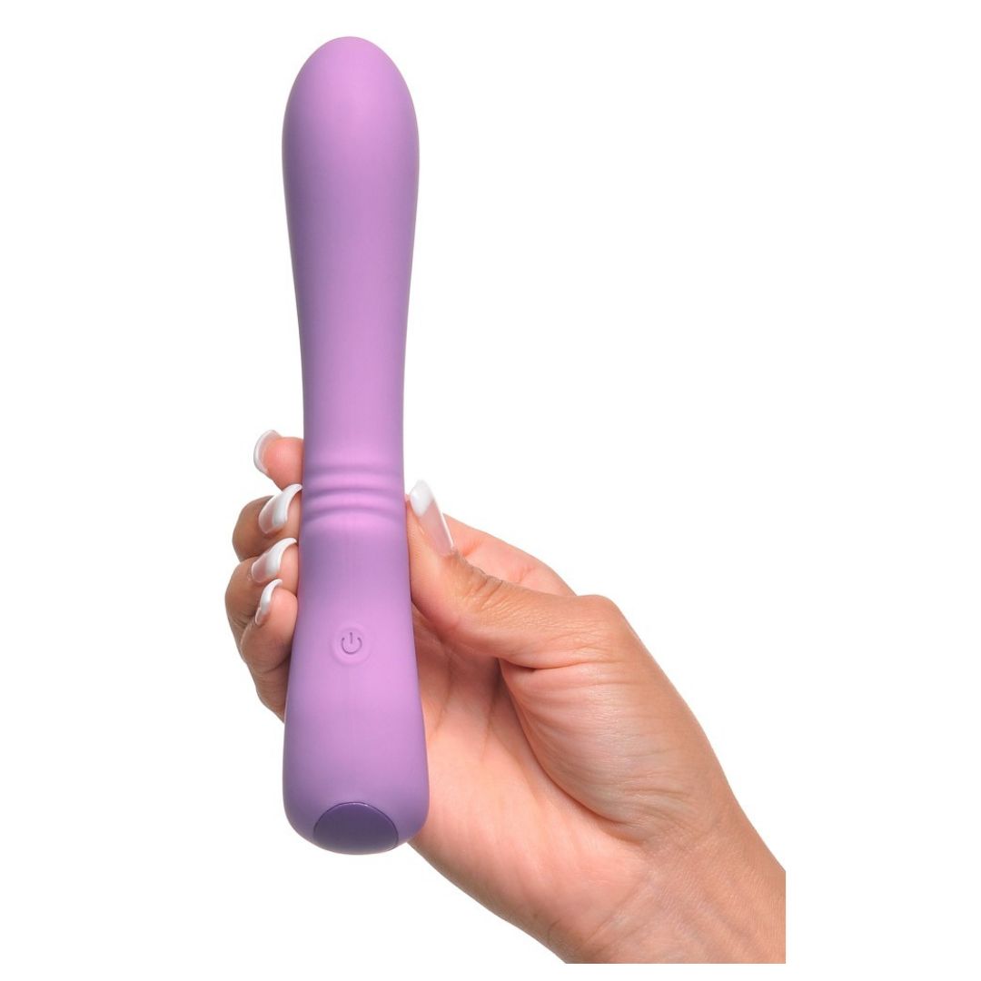Lila Vibrator in einer Hand gehalten. Mit einem Knopf und geriffelter Oberfläche.