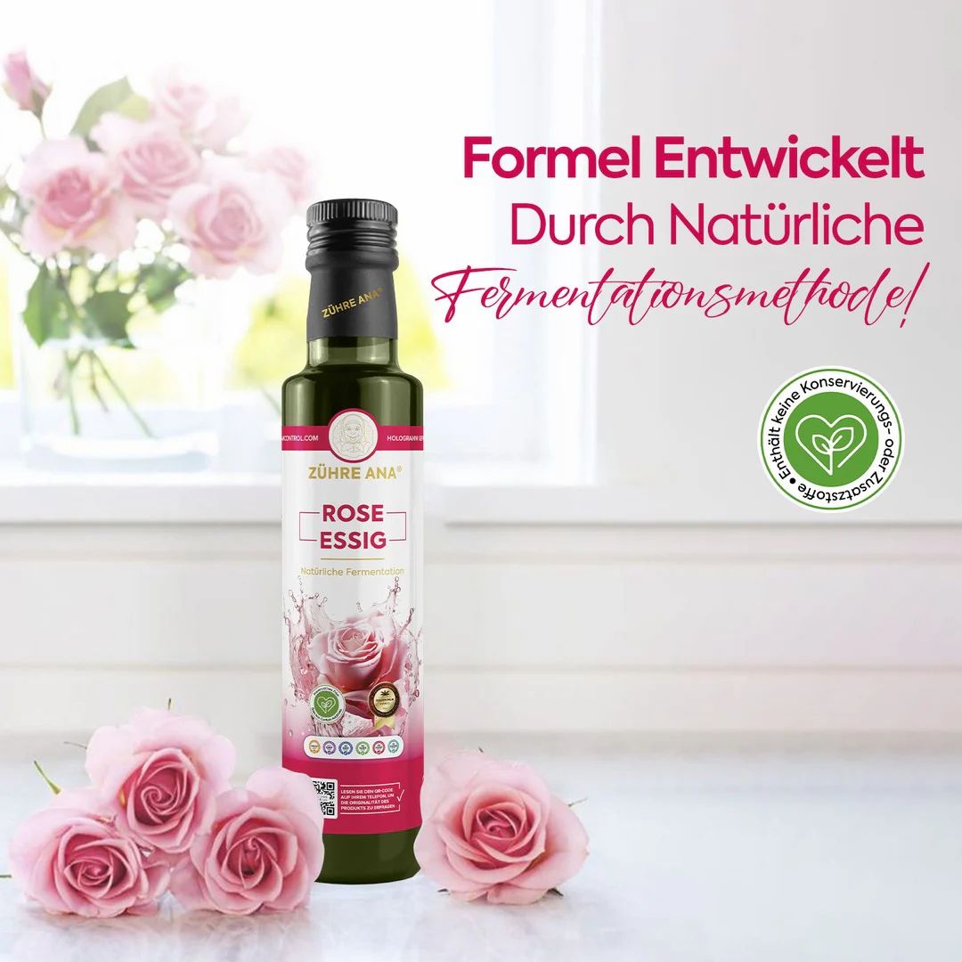 Grüne Flasche mit schwarzem Deckel, "Zühre Ana Rose Essig". Rosen und Text: "Formel Entwickelt Durch Natürliche Fermentationsmethode!"
