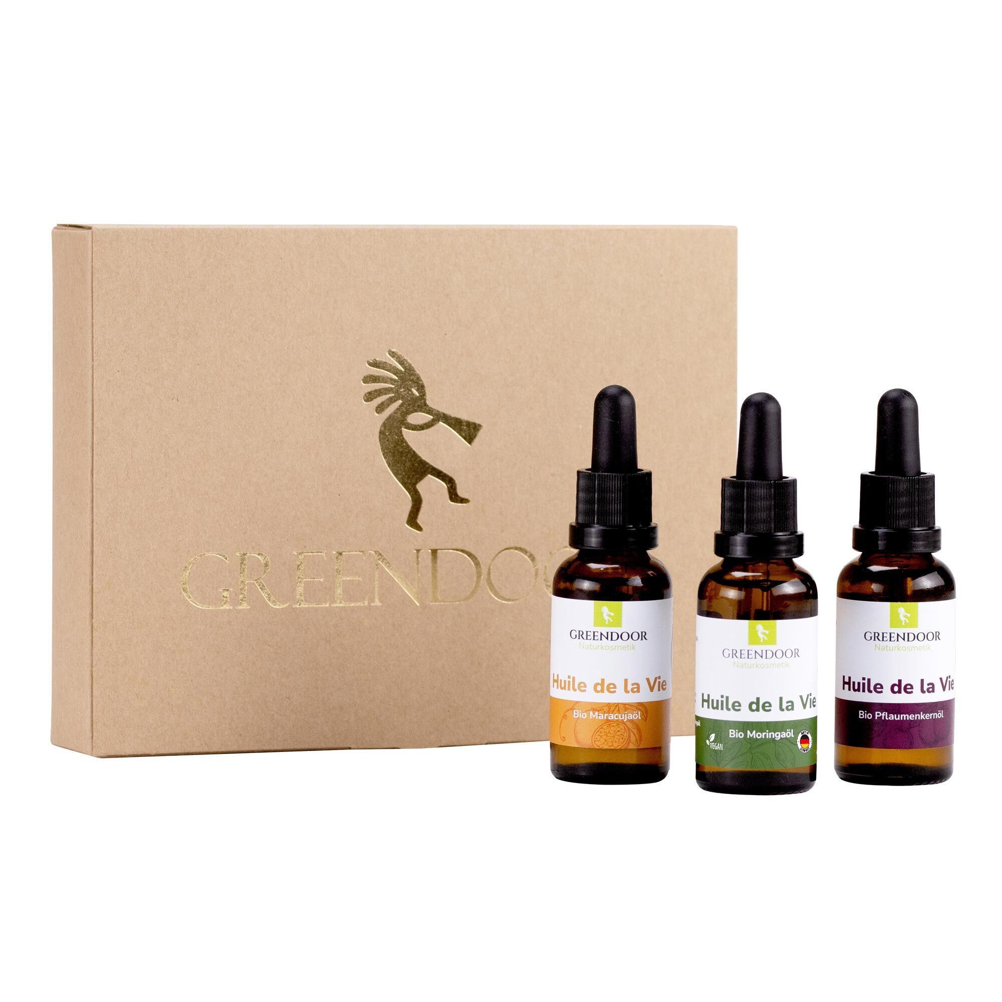 GREENDOOR Geschenk Set mit drei Ölen in Tropfflaschen, verpackt in einer braunen Kartonbox mit goldener Prägung.