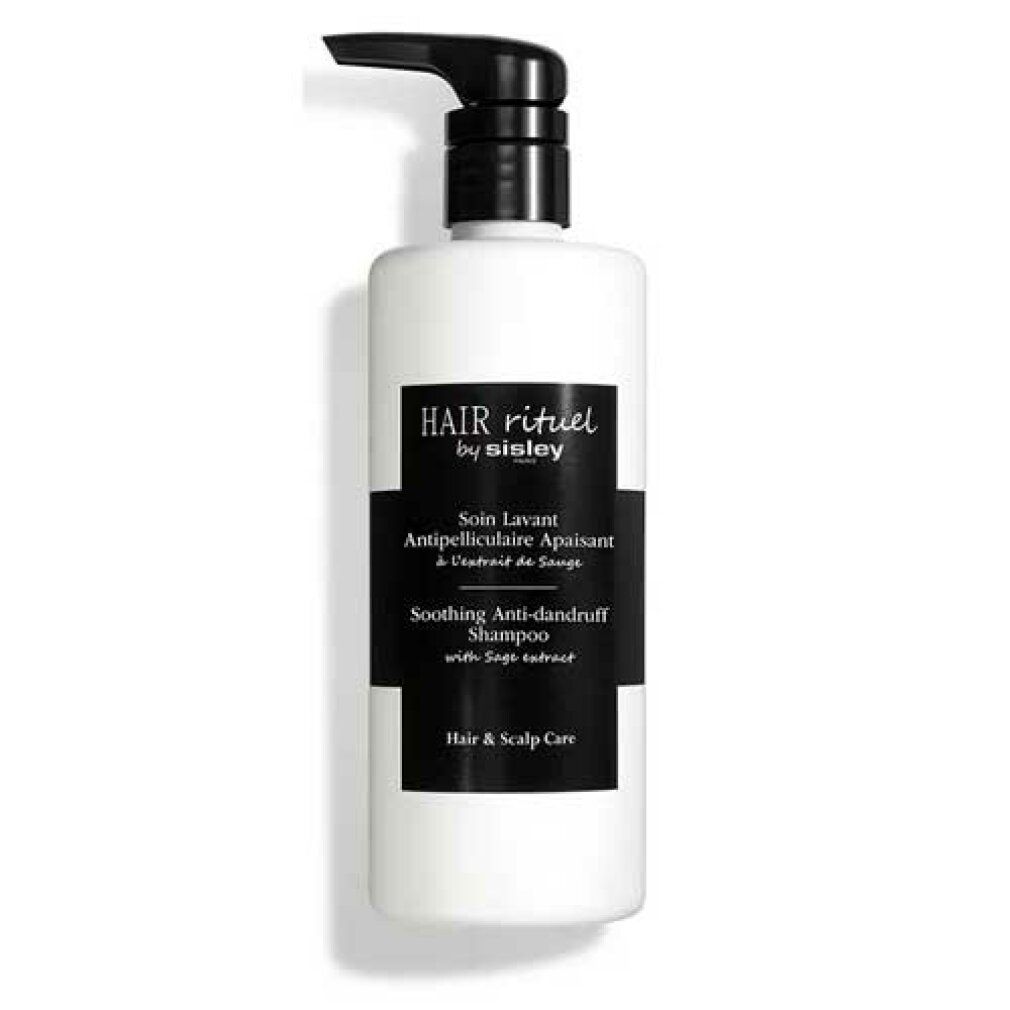 Weißer Behälter mit schwarzem Pumpkopf. Schwarzes Etikett mit Text: Hair Rituel by Sisley, Soin Lavant Antipelliculaire Apaisant, Soothing Anti-dandruff Shampoo.