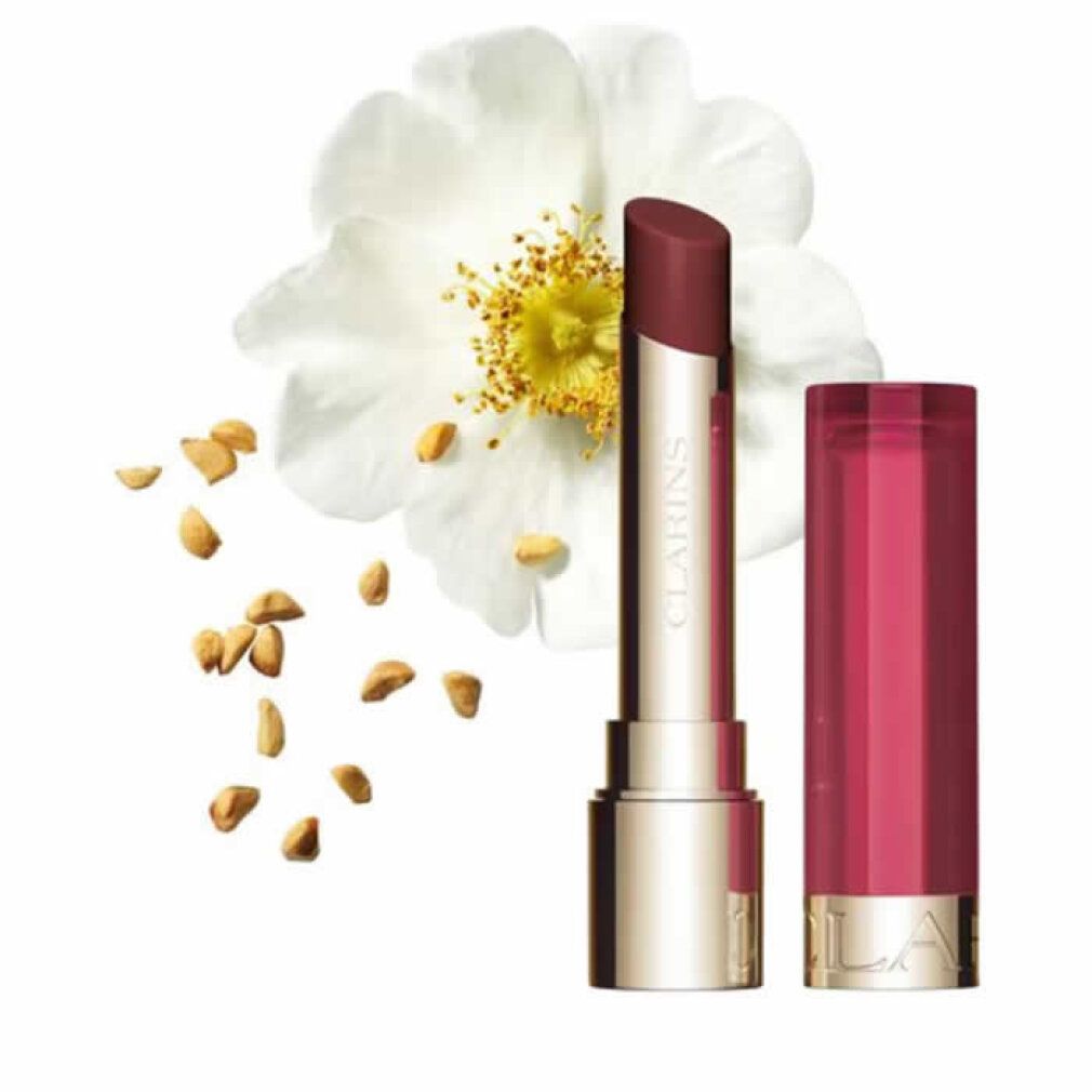 Lippenbalsam mit geöffneter Kappe und Stift. Goldfarbener Boden, transparenter Deckel. Aufschrift.