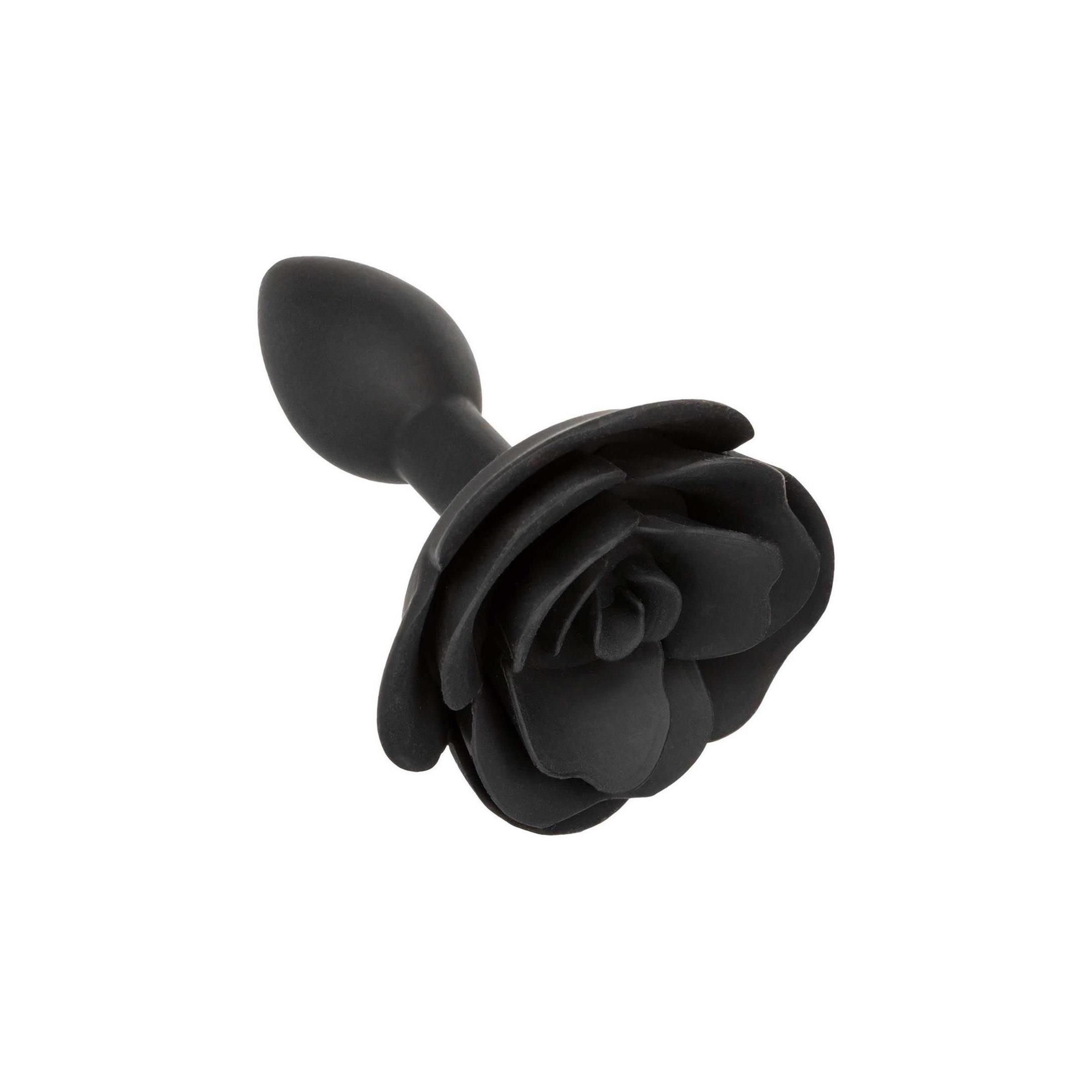 Schwarzer Anal Plug in Rosenform, leicht schräg von oben fotografiert.