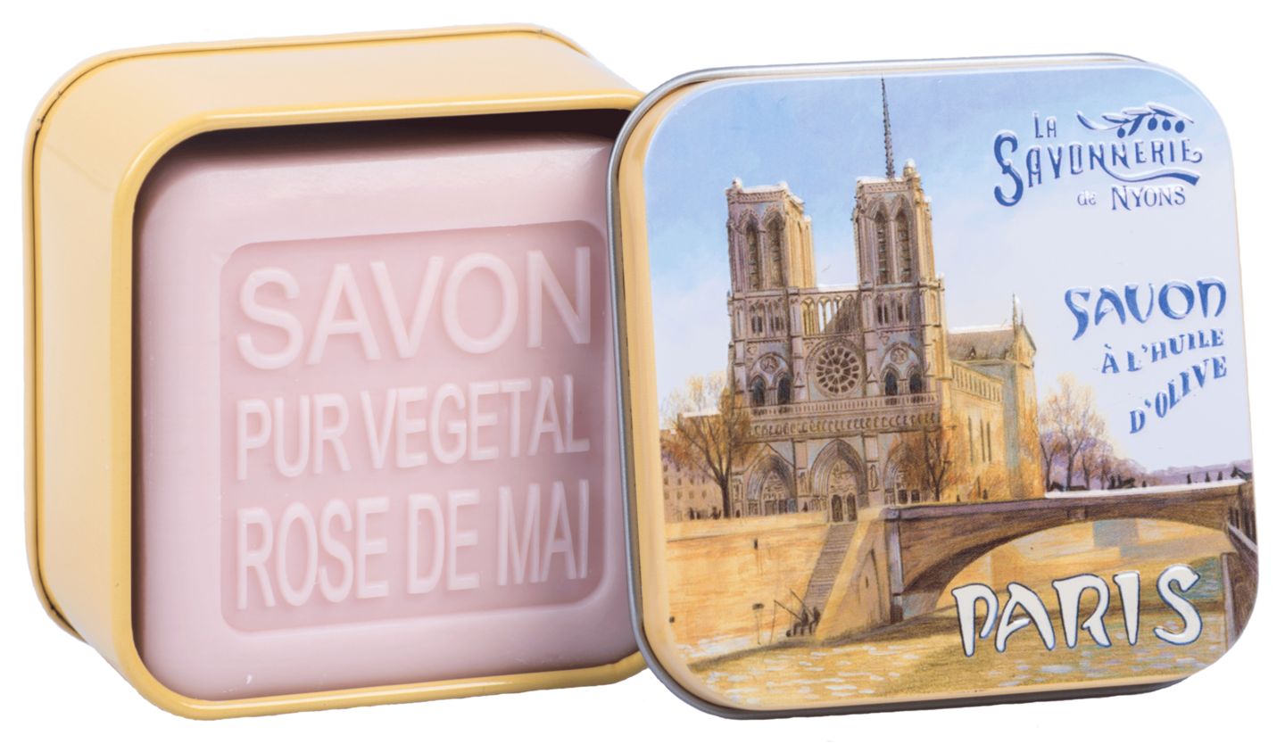 Rosa Seife in gelber Metallbox. Box mit Notre Dame-Motiv und Schriftzug "La Savonnerie de Nyons". Seife mit Text.