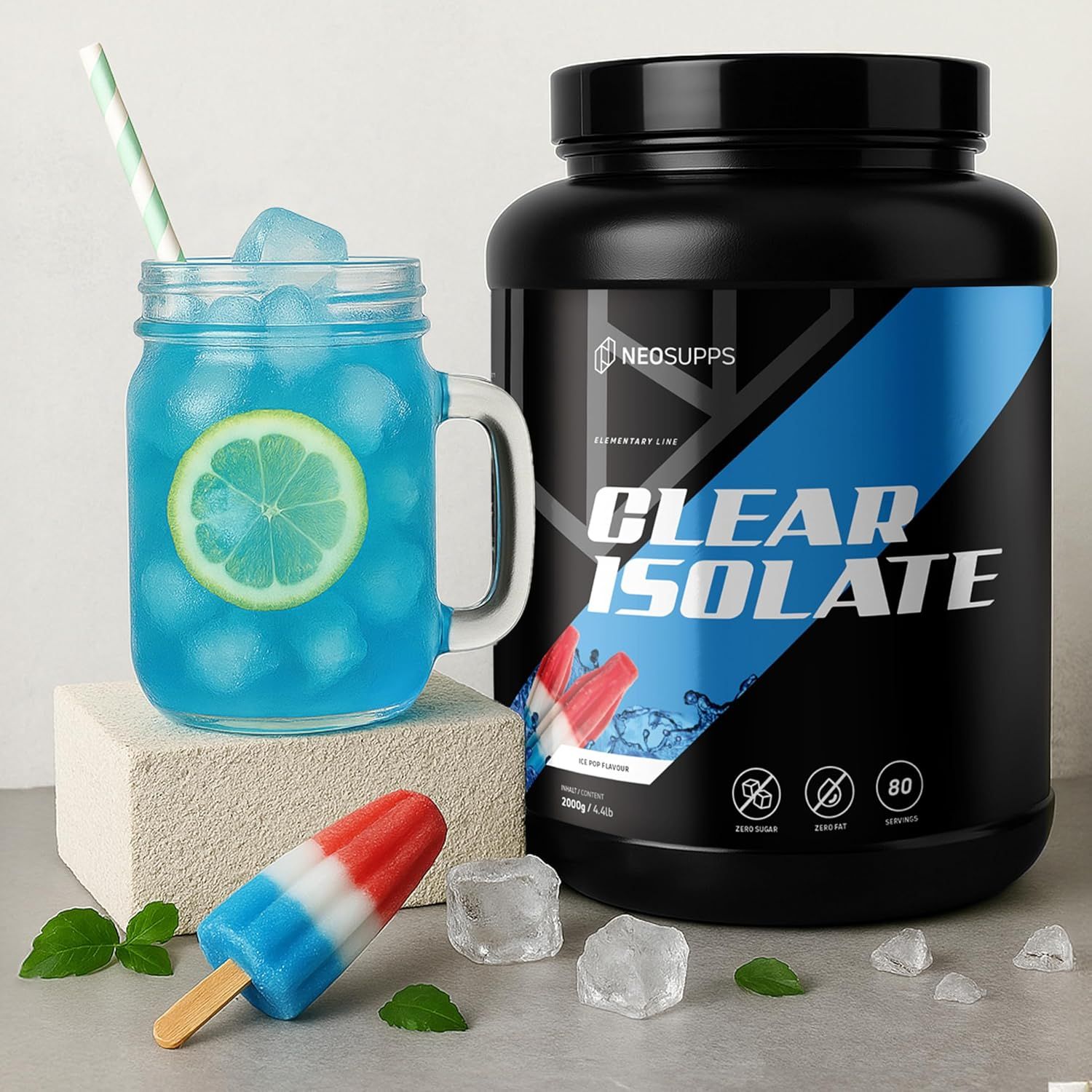 Ein Glas mit blauem Getränk, Eiswürfeln und Zitrone. Daneben eine Dose "Clear Isolate" und ein Eis am Stiel.