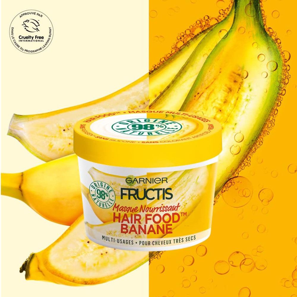 Gelbes Tiegel mit Garnier Fructis Hair Food Banane. Aufschrift: Masque Nourrissant. Banane-Illustrationen. Cruelty Free-Logo.