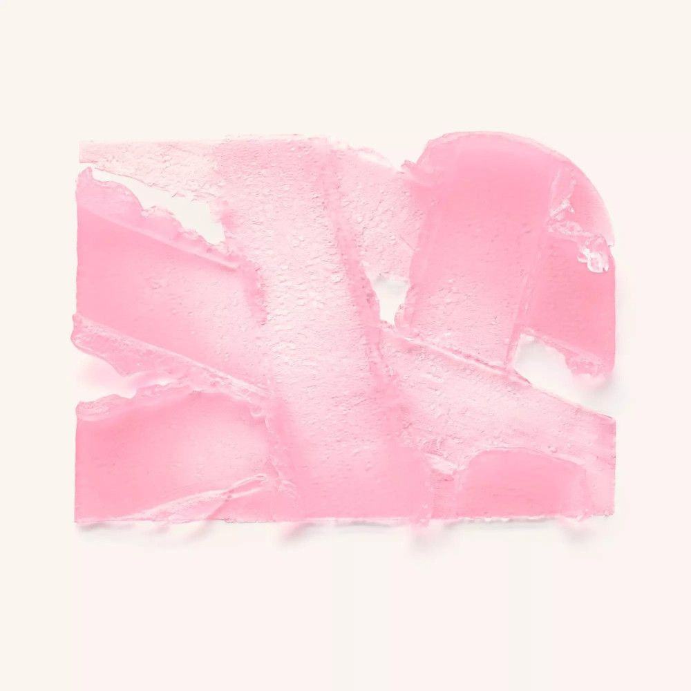 Rosa Farbkleckse auf weißem Hintergrund. Textur des Produkts sichtbar.