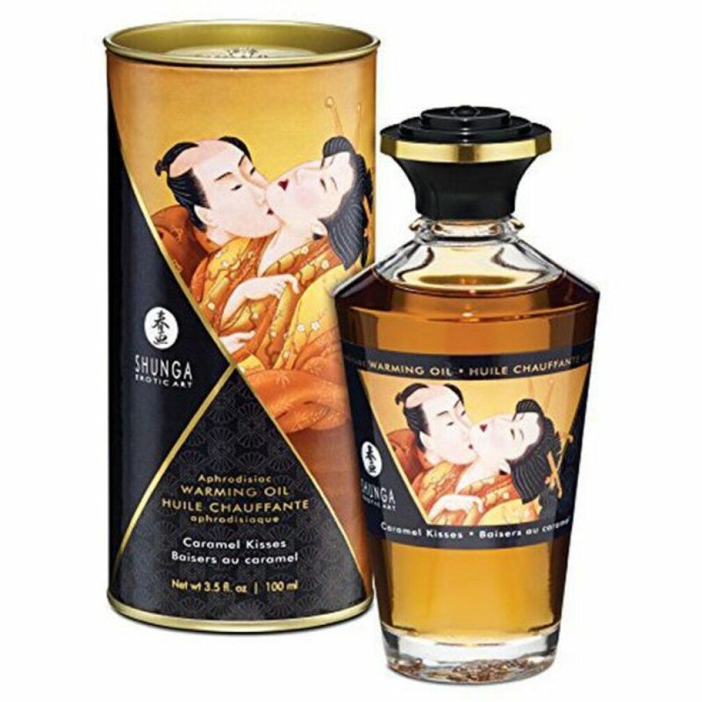 Ölflasche und Verpackung. Aufschrift: Warming Oil, Caramel Kisses. Abbildung eines küssenden Paares. Marke: Shunga.