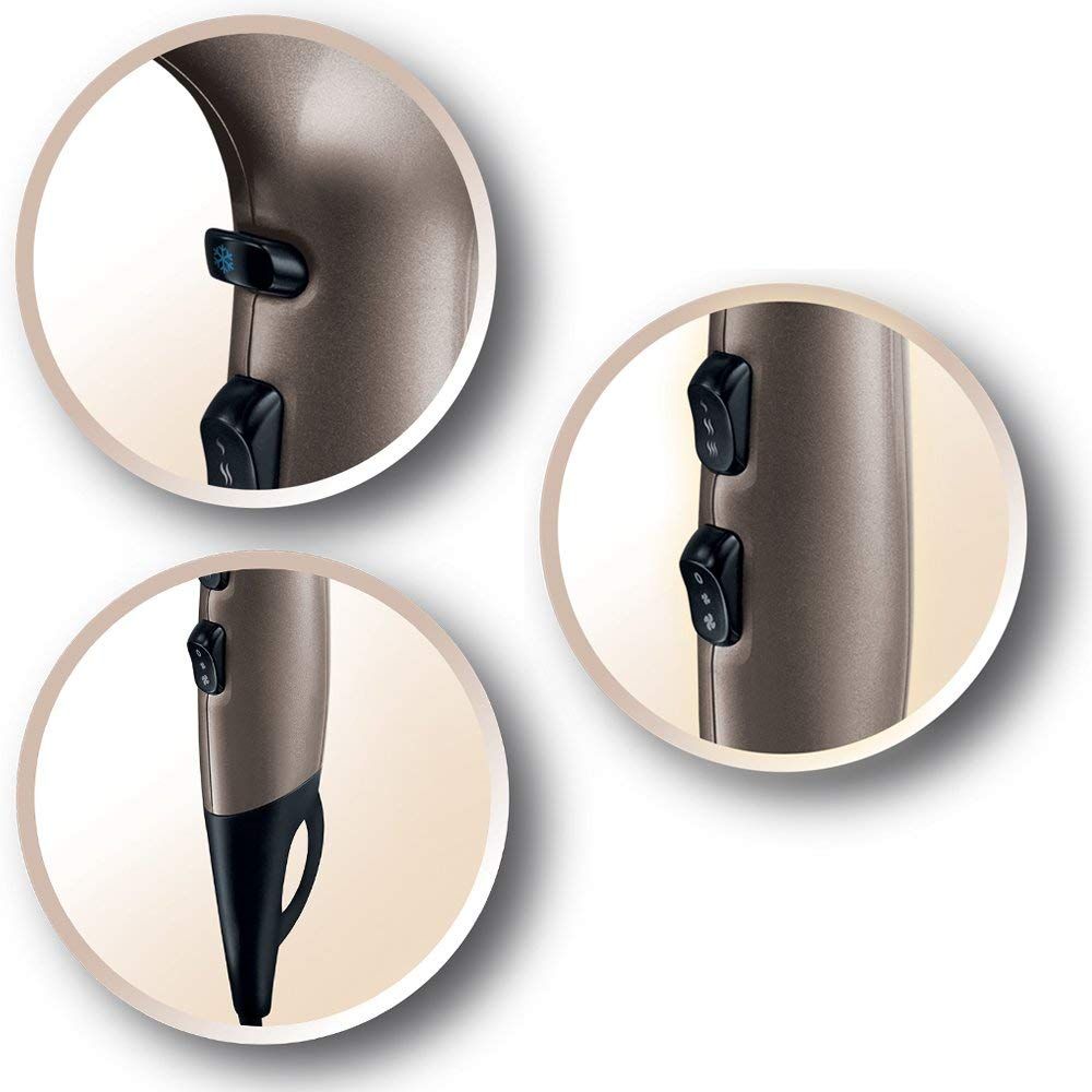 Nahaufnahmen von drei Schaltern am Haartrockner. Details der Schalter und des Griffs in Anthrazit-Gold.