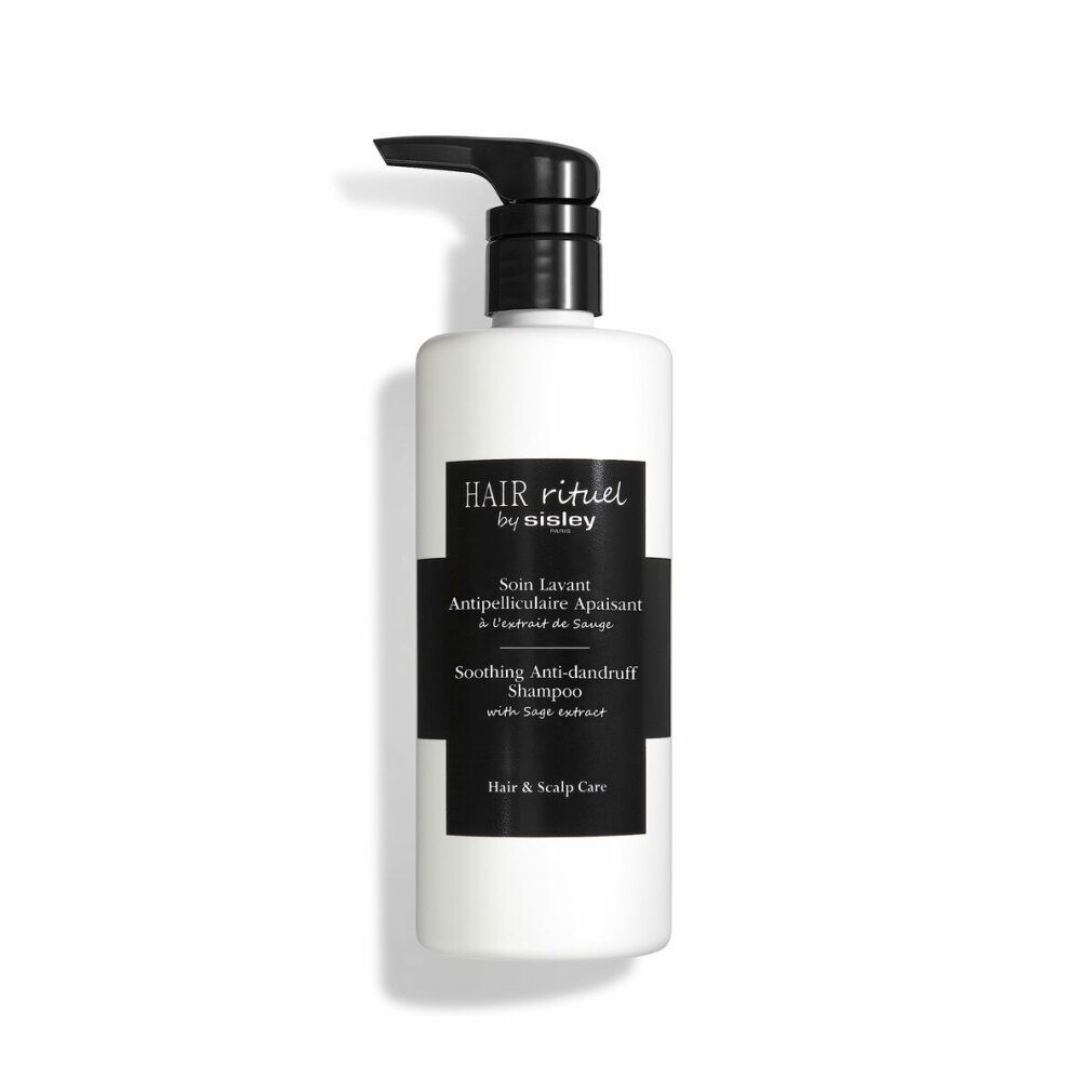 Weißer Behälter mit schwarzem Pumpkopf. Schwarzes Etikett mit Text: Hair Rituel by Sisley, Soin Lavant Antipelliculaire Apaisant, Soothing Anti-dandruff Shampoo.
