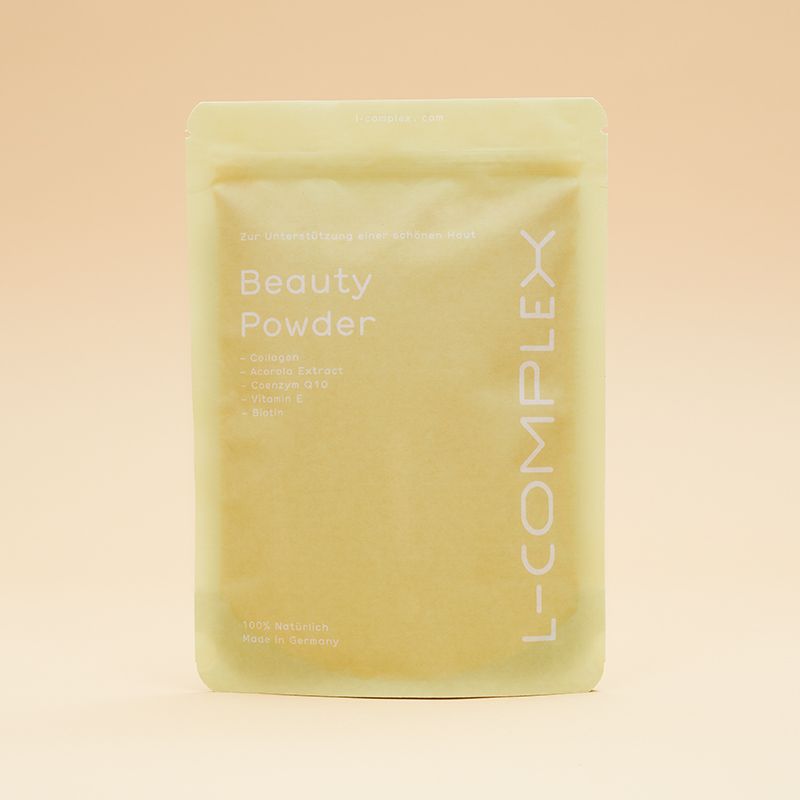 Gelber Beutel mit Beauty Powder. Aufschrift: L-COMPLEX, Beauty Powder. Enthält Selen, Vitamin C, etc.