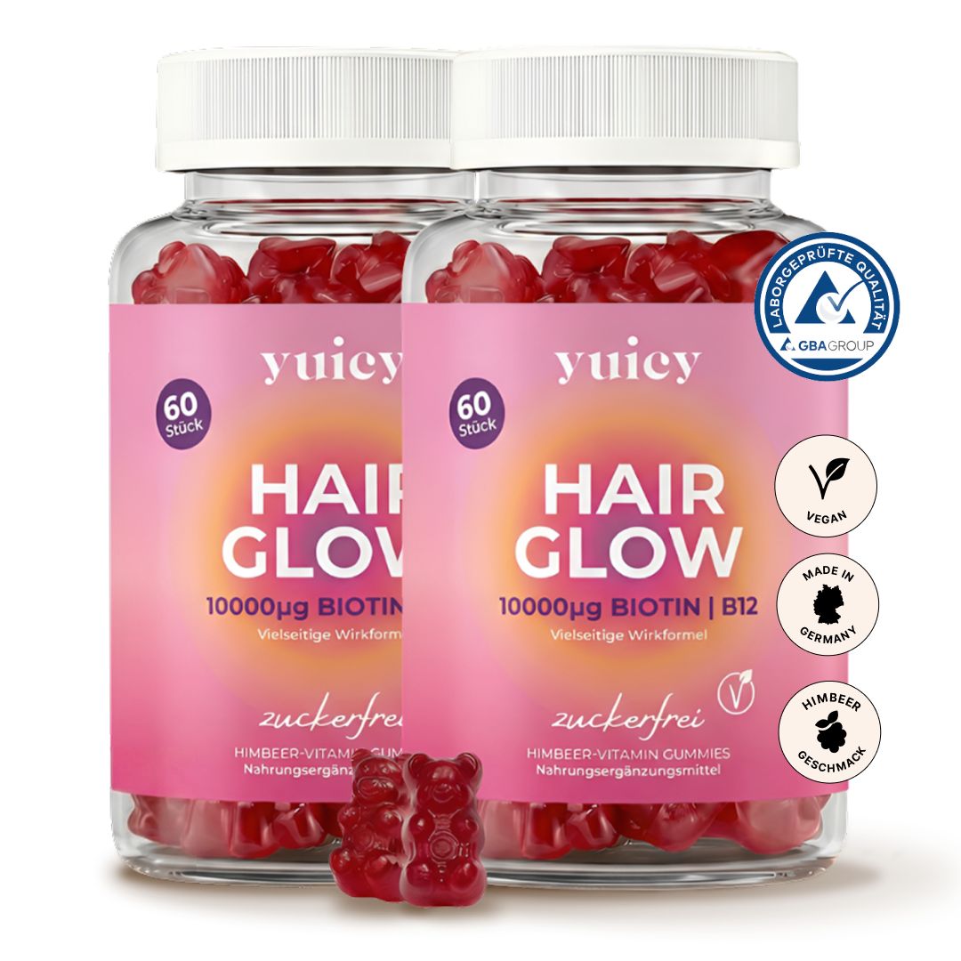 Zwei Flaschen yuicy® Hair Glow Gummibärchen. Rosa Etikett mit Text. 60 Stück. Vegan, zuckerfrei, Himbeergeschmack. GBA-Qualitätssiegel.