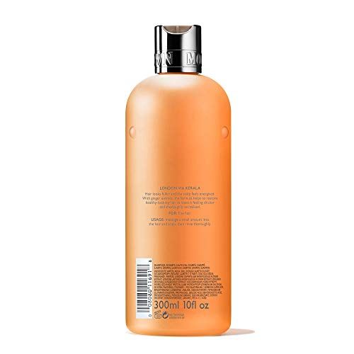 Rückseite der Molton Brown Shampoo-Flasche. Orangefarbene Flasche mit Text und silbernem Deckel. Text: London via Kerala, 300ml 10 fl oz.