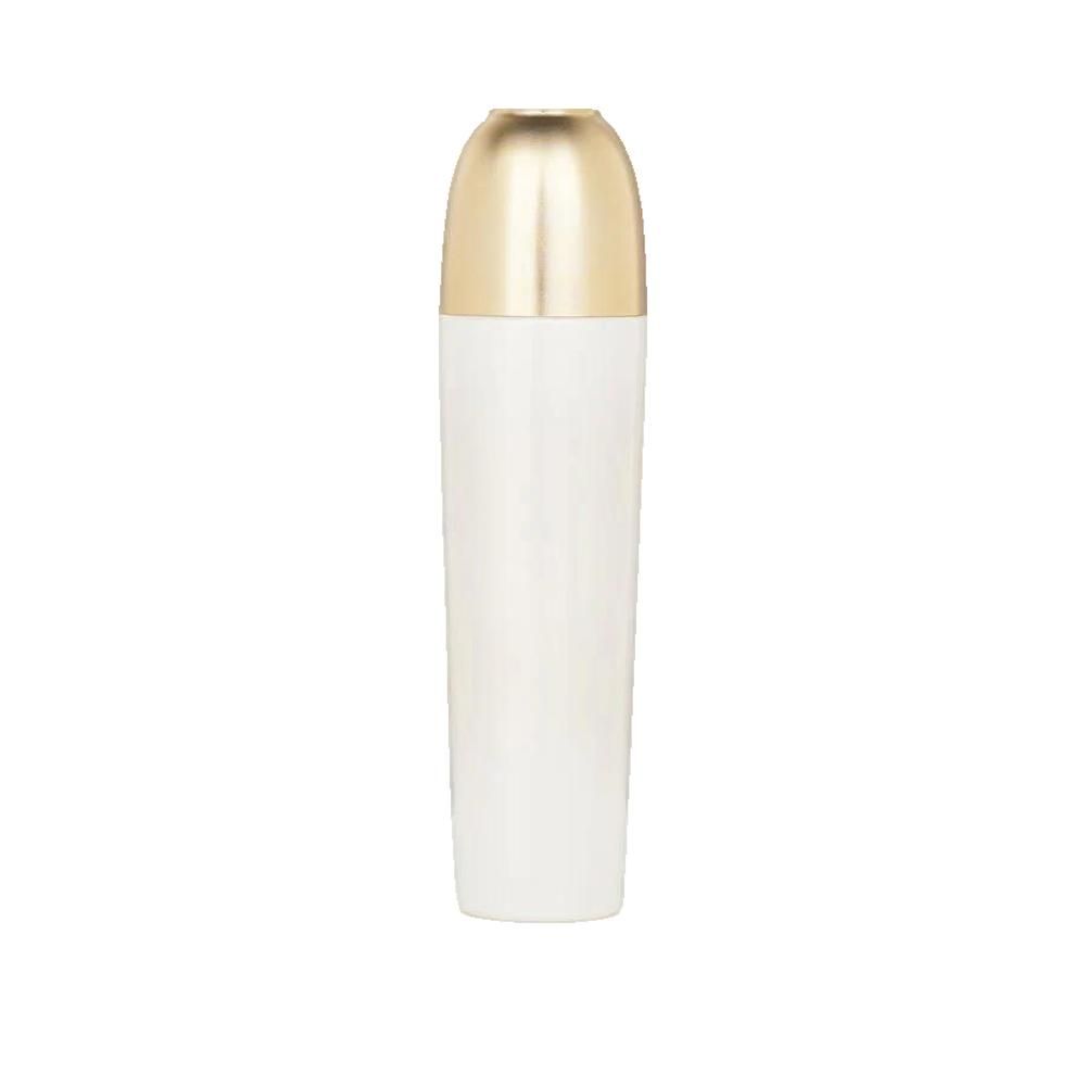 Weißes, zylindrisches Fläschchen mit goldfarbenem Deckel. Der Deckel ist länglich und abgerundet. Keine weiteren Details.