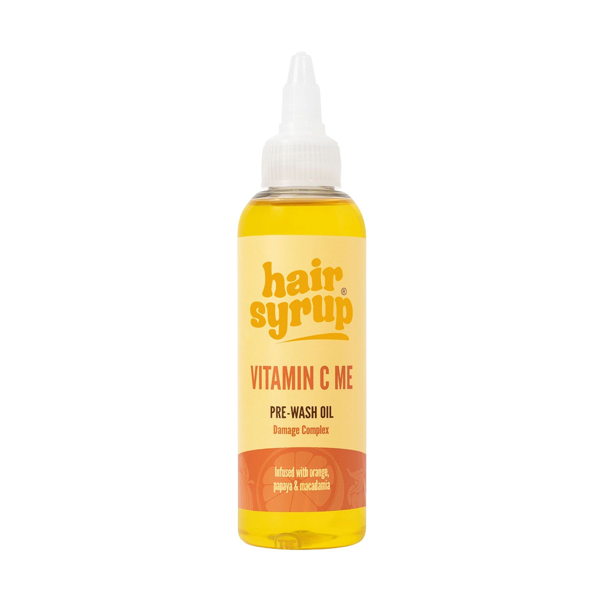 Gelbe Flasche mit Produkt. Aufschrift: Hair Syrup Vitamin C Me, Pre-Wash Oil.