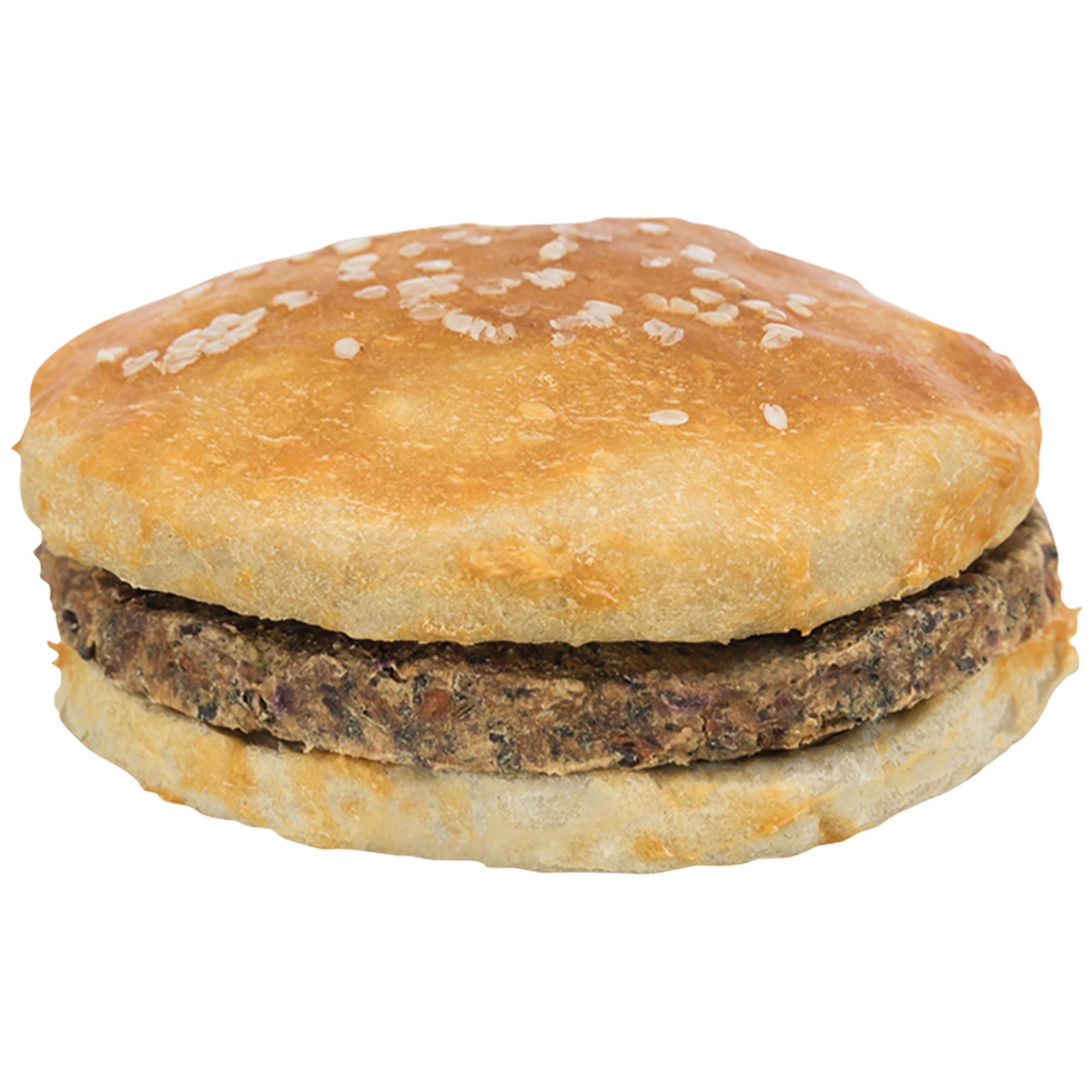 Hunde-Burger, rund, mit hellem Brötchen und dunklem Fleisch. Oben mit Sesamkörnern bestreut.