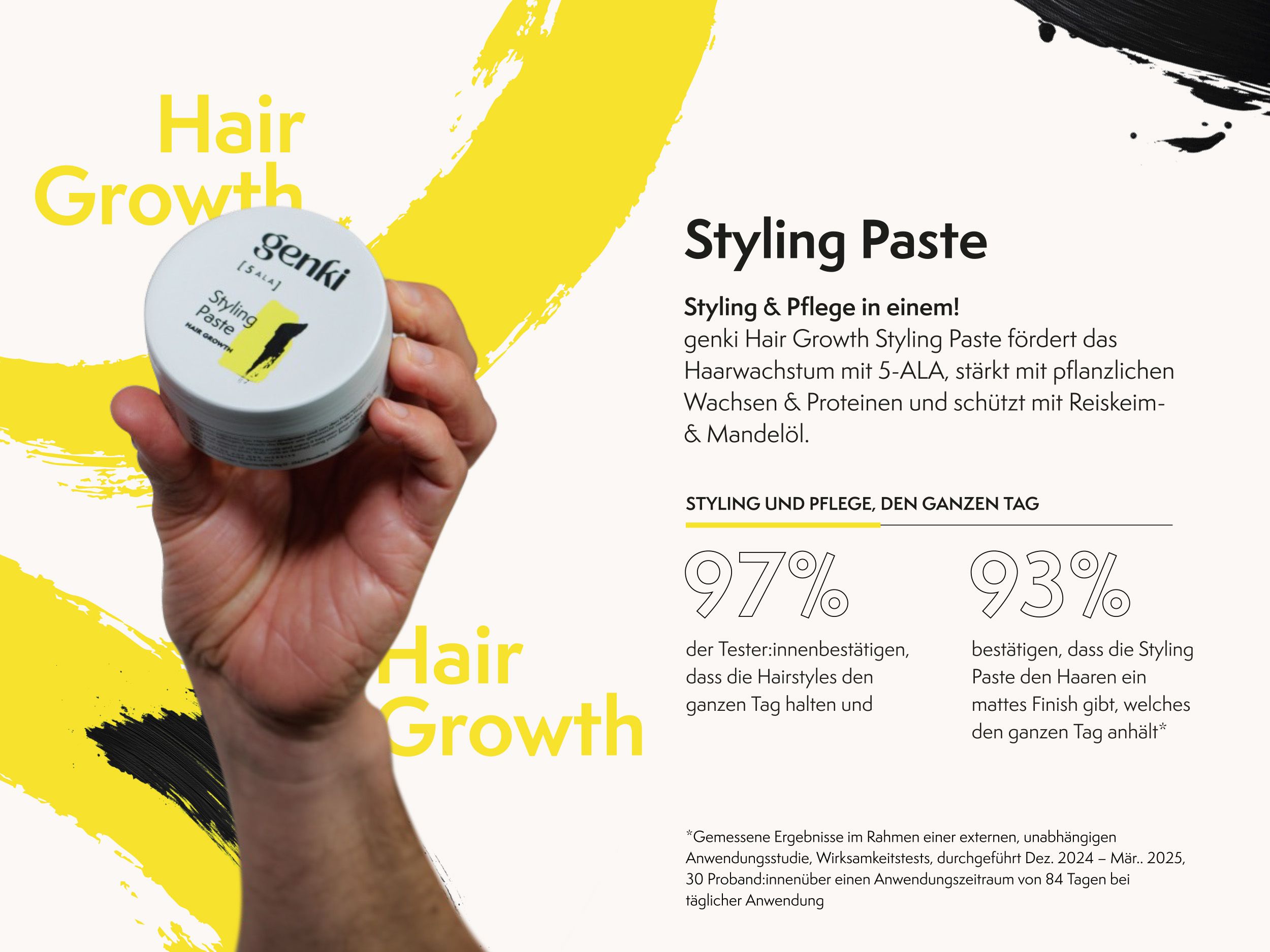 Hand hält Genki Styling Paste Dose. Grauer Deckel, schwarzer Schriftzug, gelber Farbfleck. Text.