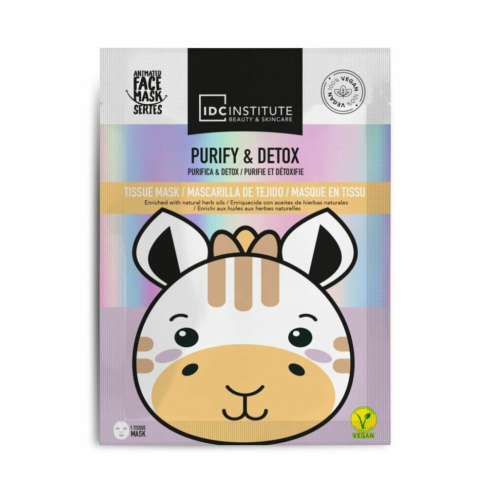 Gesichtsmaske mit Giraffen-Design. Verpackung mit Aufschrift 'Purify & Detox' und 'IDC Institute'. Vegan-Siegel.