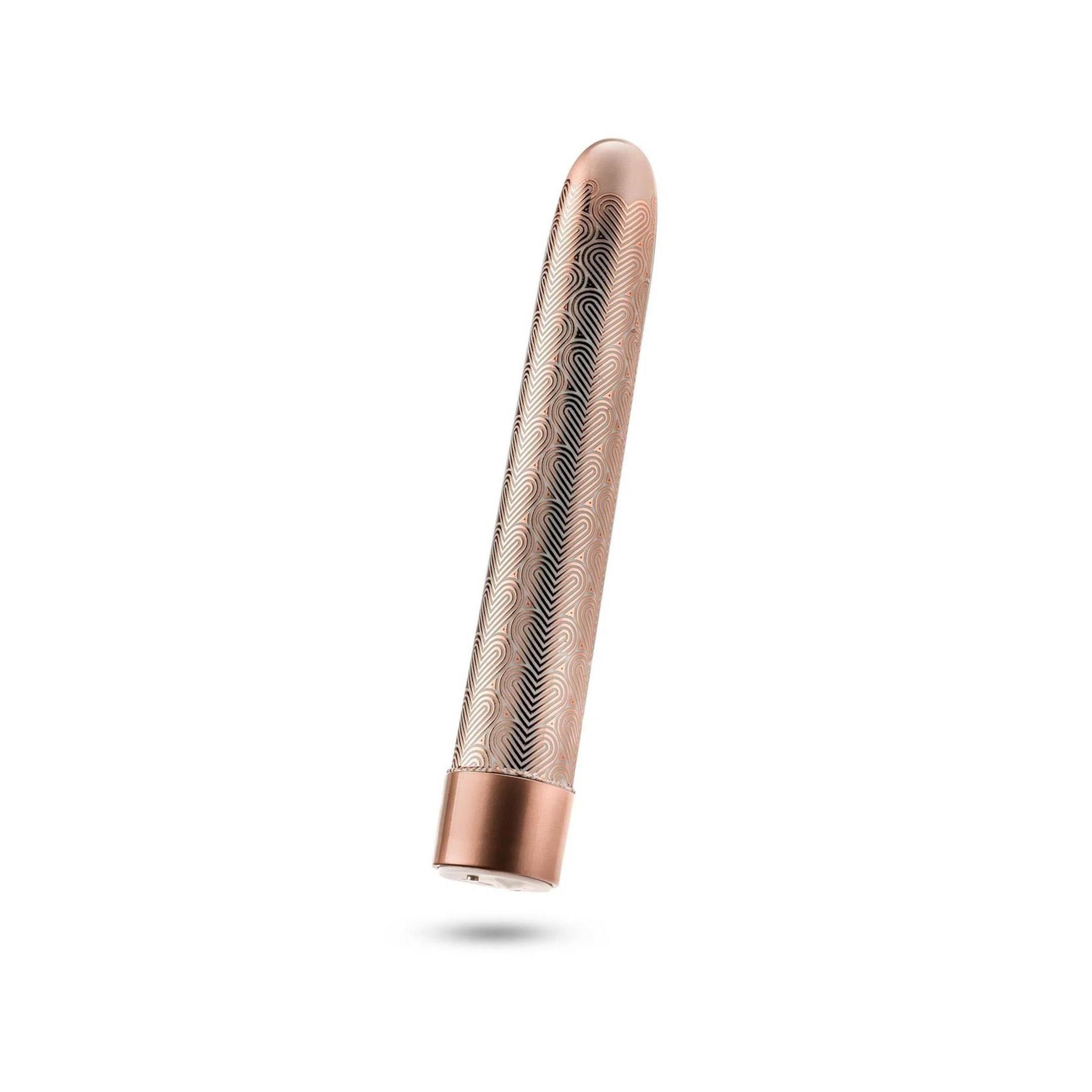 Zylindrisches Wellness-Produkt in Roségold mit wellenförmigem Muster. Unterteil und Spitze sind glatt.