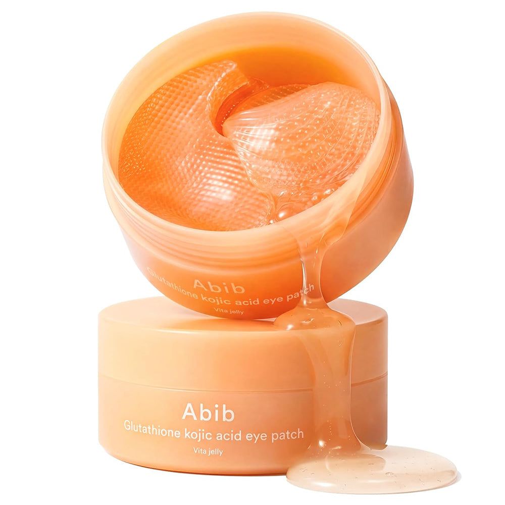 Abib Augenpads in einem offenen, orangefarbenen Tiegel, mit Serum getränkt.