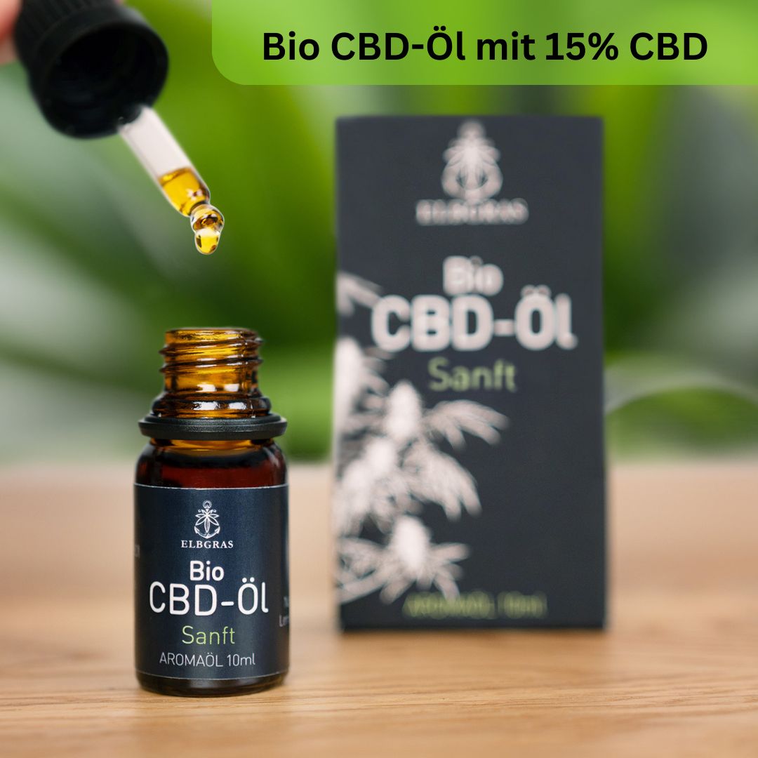 Braune Glasflasche mit Tropfer. Tropfen Öl. Schwarze Verpackung mit Logo und Schriftzug. Bio CBD-Öl.