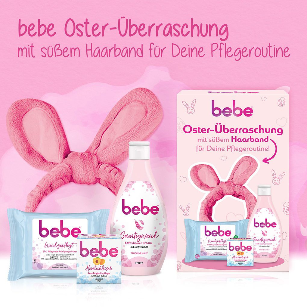 Bebe-Produkte: Reinigungstücher, Feuchtigkeitspflege, Soft Shower Cream und Haarband. Auf rosa Hintergrund.