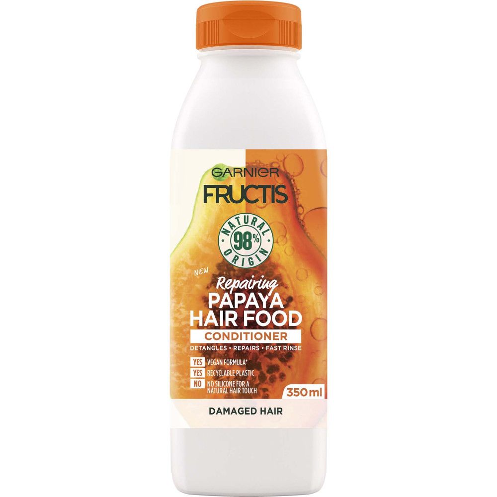 Flasche Garnier Fructis Papaya Hair Food Spülung. Weißes Gefäß mit orangefarbenem Deckel. Produktinformationen und Logo.