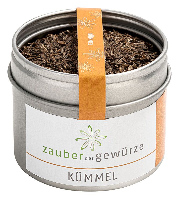 Metallbehälter mit Kümmel. Etikett mit "Zauber der Gewürze Kümmel". Orangefarbener Streifen mit "Kümmel"-Aufdruck.
