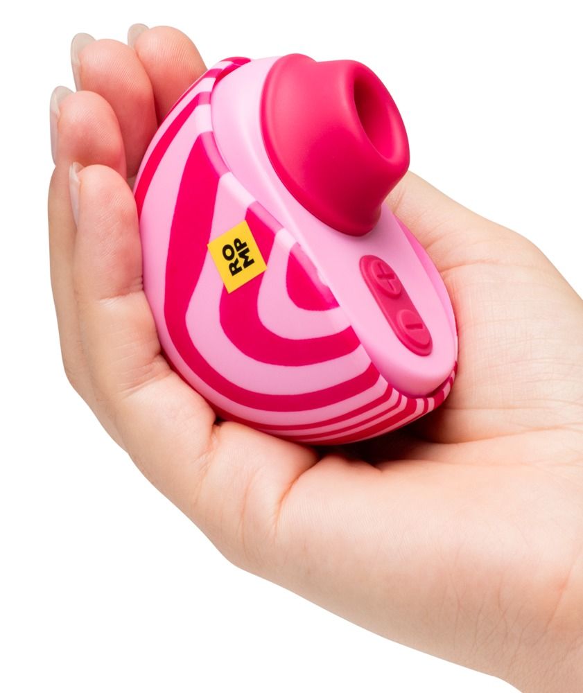 Rosa Vibrator in einer Hand gehalten. Pinke Streifen. Gelbes ROMP Logo. Zwei Knöpfe.