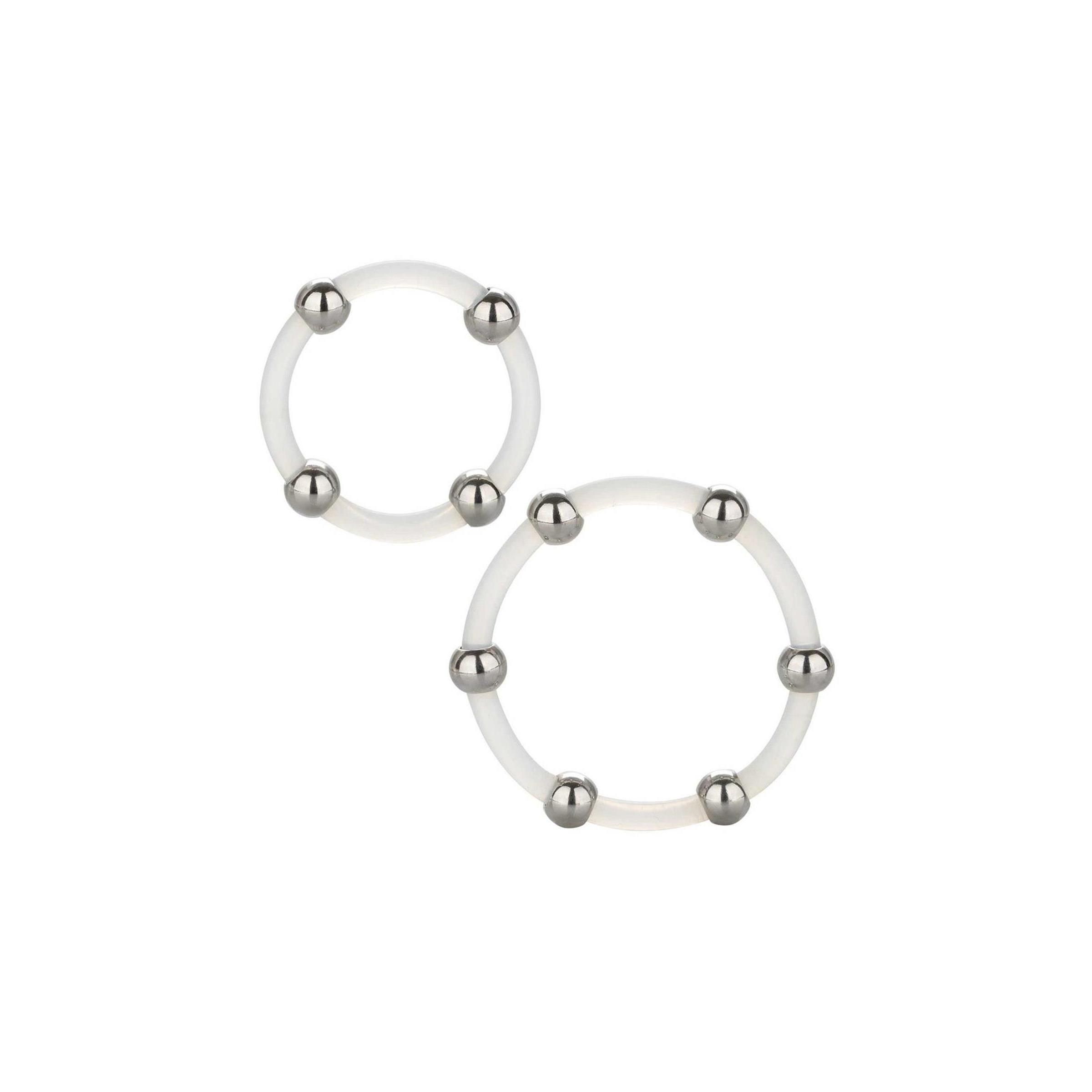 Zwei transparente Silikonringe mit je sechs Metallkugeln. Die Ringe liegen auf weißem Hintergrund.