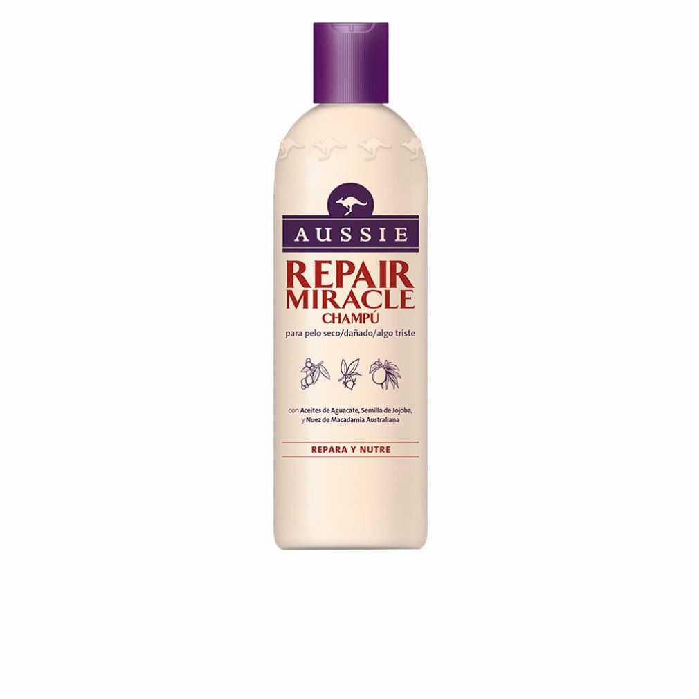 Beige Shampoo-Flasche mit lila Deckel. Aufschrift: Aussie Repair Miracle Champú. Enthält Avocado, Jojoba und Macadamia.