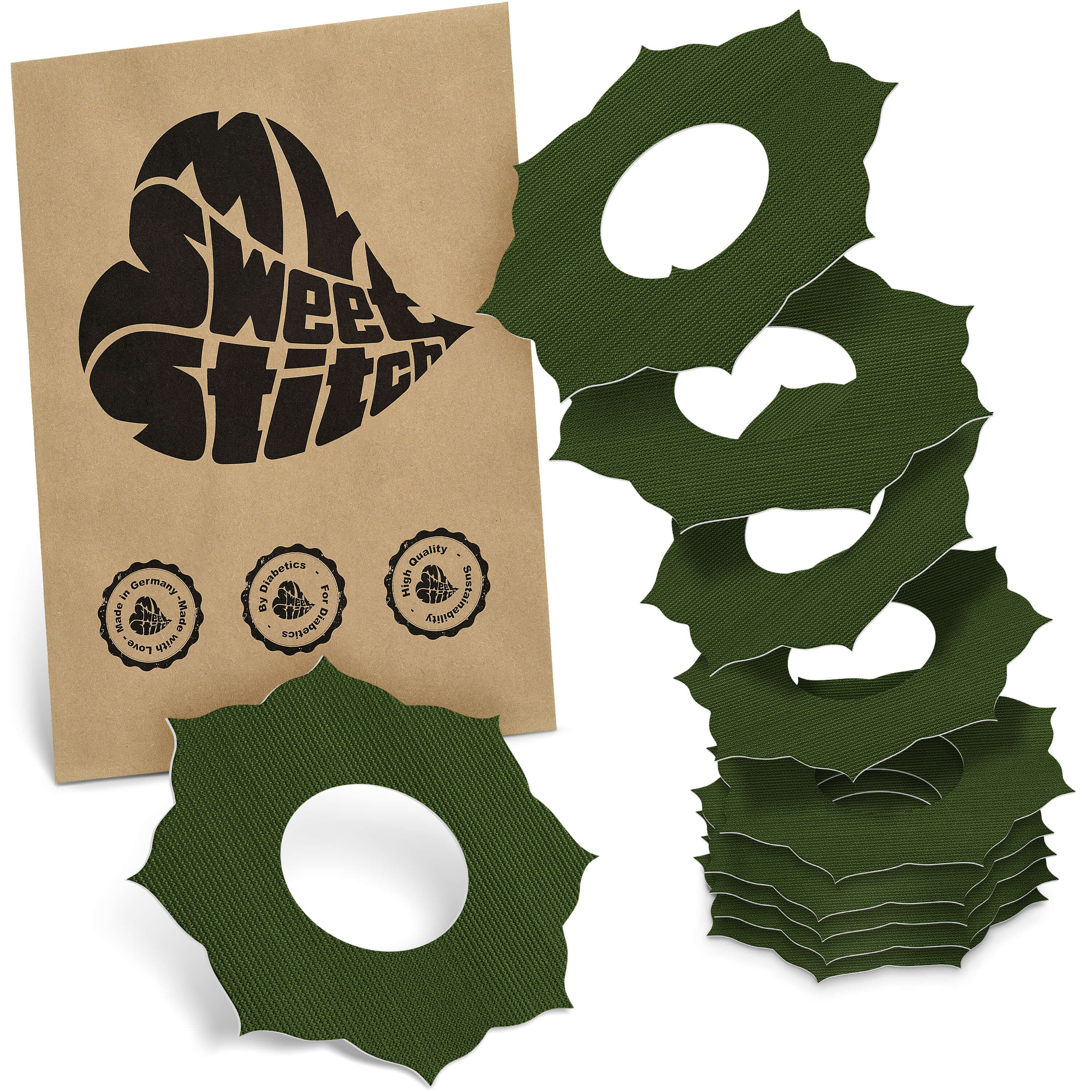 Grüne Ringpflaster mit Loch, neben brauner Verpackung mit Logo "MySweetStitch". Mehrere Pflaster gestapelt.