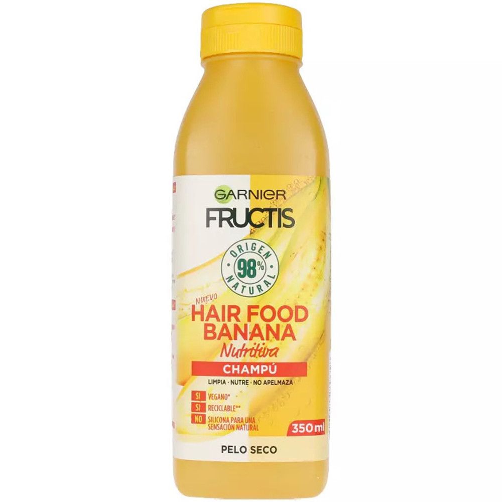 Gelbe Flasche Garnier Fructis Hair Food Banane Shampoo. Aufschrift: 98% natürlichen Ursprungs. Für trockenes Haar. Vegan, recycelbar, ohne Silikone.