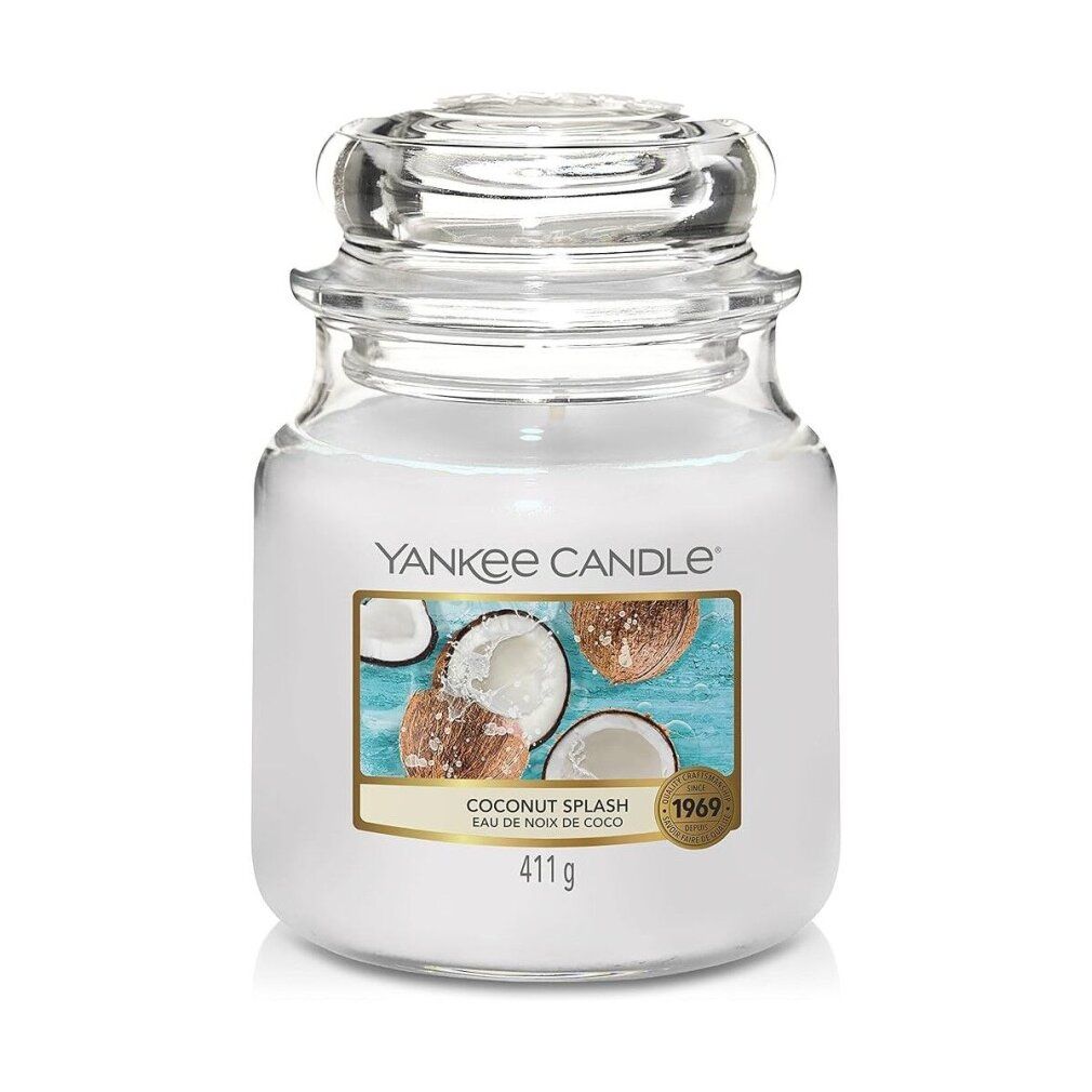 Glasbehälter mit Deckel. Aufkleber mit Kokosnuss-Motiv und Schriftzug "Yankee Candle Coconut Splash". Aufkleber mit Text "411g" und "1969".