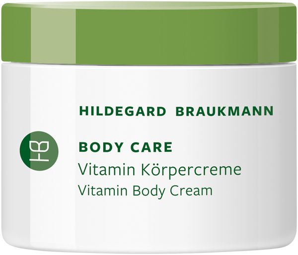 Hildegard Braukmann Body Care Vitamin Körpercreme in einem weißen Tiegel mit grünem Deckel. Produktname und Logo sind aufgedruckt. Englischer Text: Vitamin Body Cream.