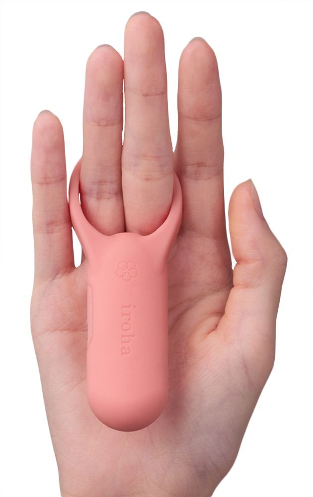Rosa Vibrator mit Ring auf Handfläche. Marke iroha.
