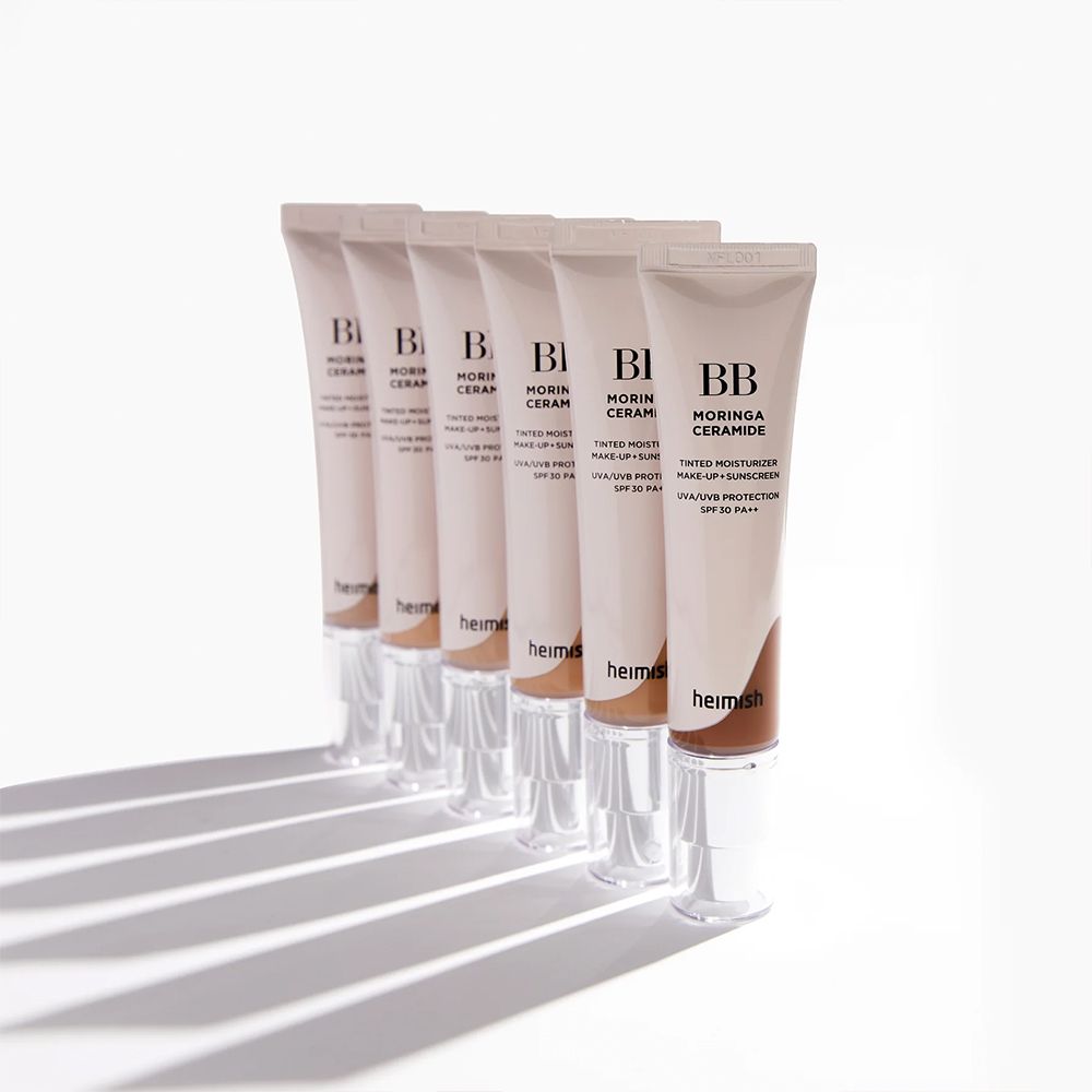 Reihe von BB Moringa Ceramide BB-Cremetuben, die auf einer weißen Oberfläche stehen.
