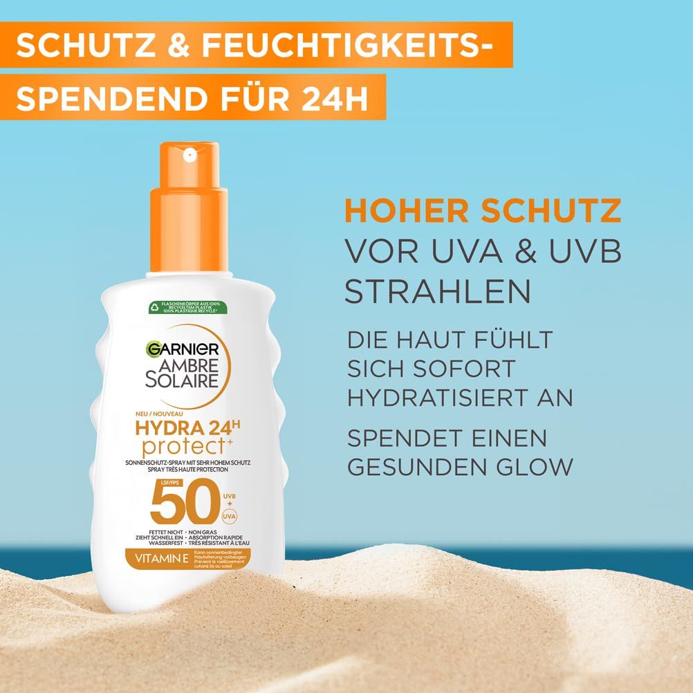 Sonnenschutzspray auf Sand. Text: Garnier Ambre Solaire Hydra 24H Protect+, LSF 50. Hoher Schutz vor UVA & UVB.