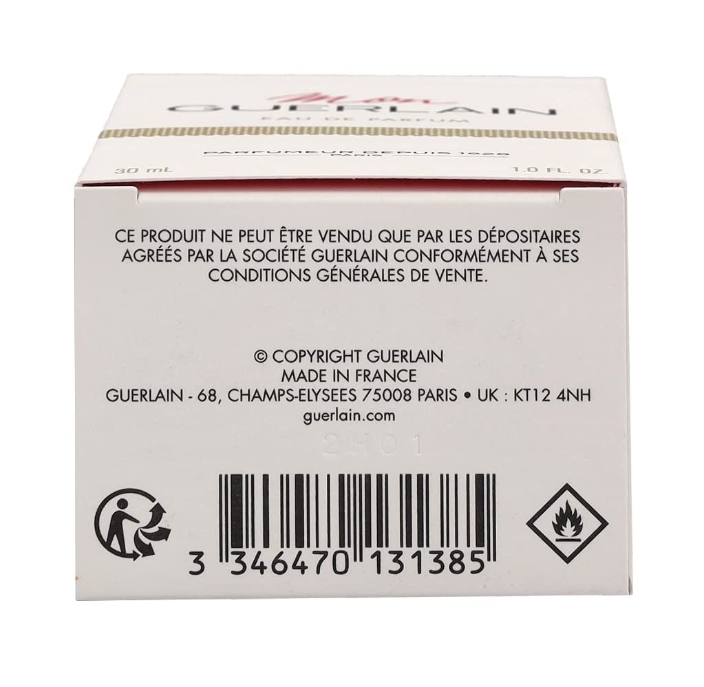 Rückseite einer weißen Schachtel mit Text und Barcode. Guerlain-Logo und Adresse sind sichtbar.