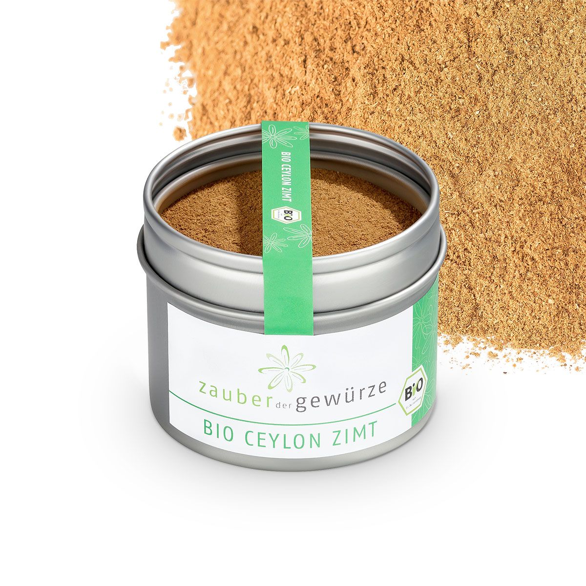 Zylindrische Dose mit Zimtpulver. Aufkleber mit "Zauber der Gewürze Bio Ceylon Zimt" und Bio-Siegel. Zimtpulver daneben.