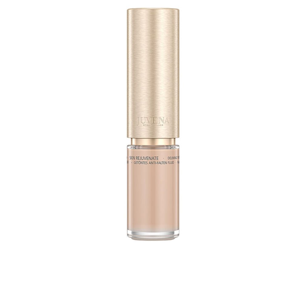 Flakon Juvena of Switzerland Delining Tinted Fluid SPF 10. Beige Flüssigkeit, goldener Deckel.