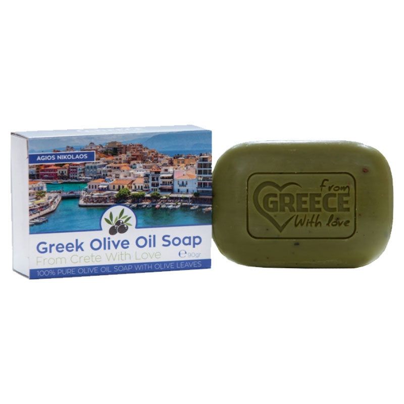 Olivenölseife mit Verpackung. Die Seife ist grün und rechteckig mit abgerundeten Ecken. Auf der Verpackung steht "Greek Olive Oil Soap".