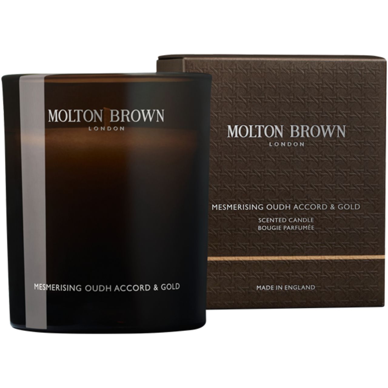 Duftkerze und Verpackung. Kerze in dunklem Glas mit weißem Streifen. Verpackung mit Aufschrift: Molton Brown London.