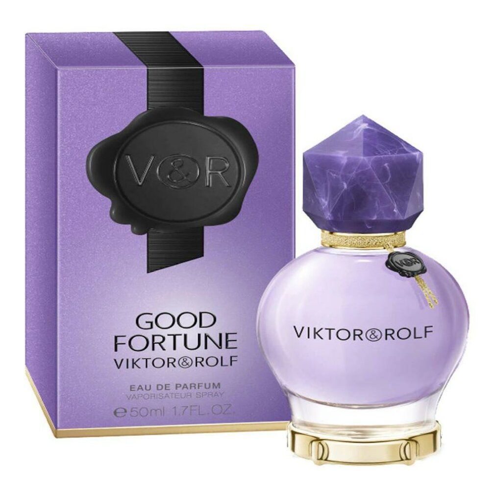 Flakon und Verpackung von Viktor & Rolf Good Fortune Edp Spray. Flakon rund, lila, mit Kristallverschluss. Verpackung lila mit schwarzem Siegel.