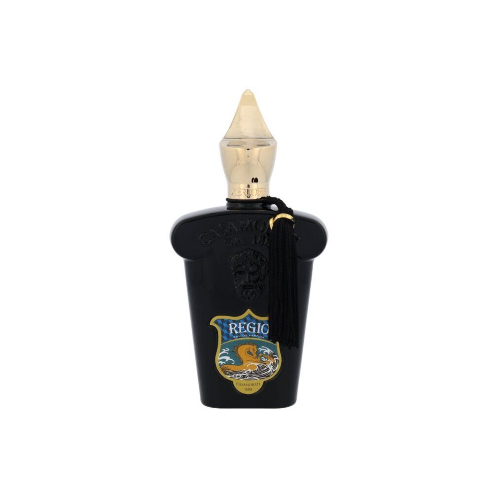 Schwarzer Flakon mit goldener Kappe und Quaste. Text: Regio, Logo.