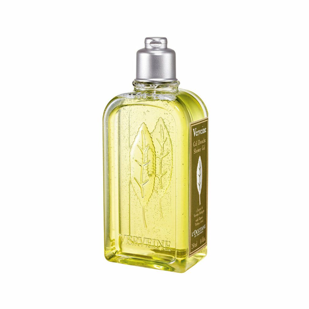 Gelbe Flüssigkeit in einer rechteckigen Flasche mit silbernem Deckel. Aufschrift: Verbene, Gel Douche, L'Occitane. Blattrelief.