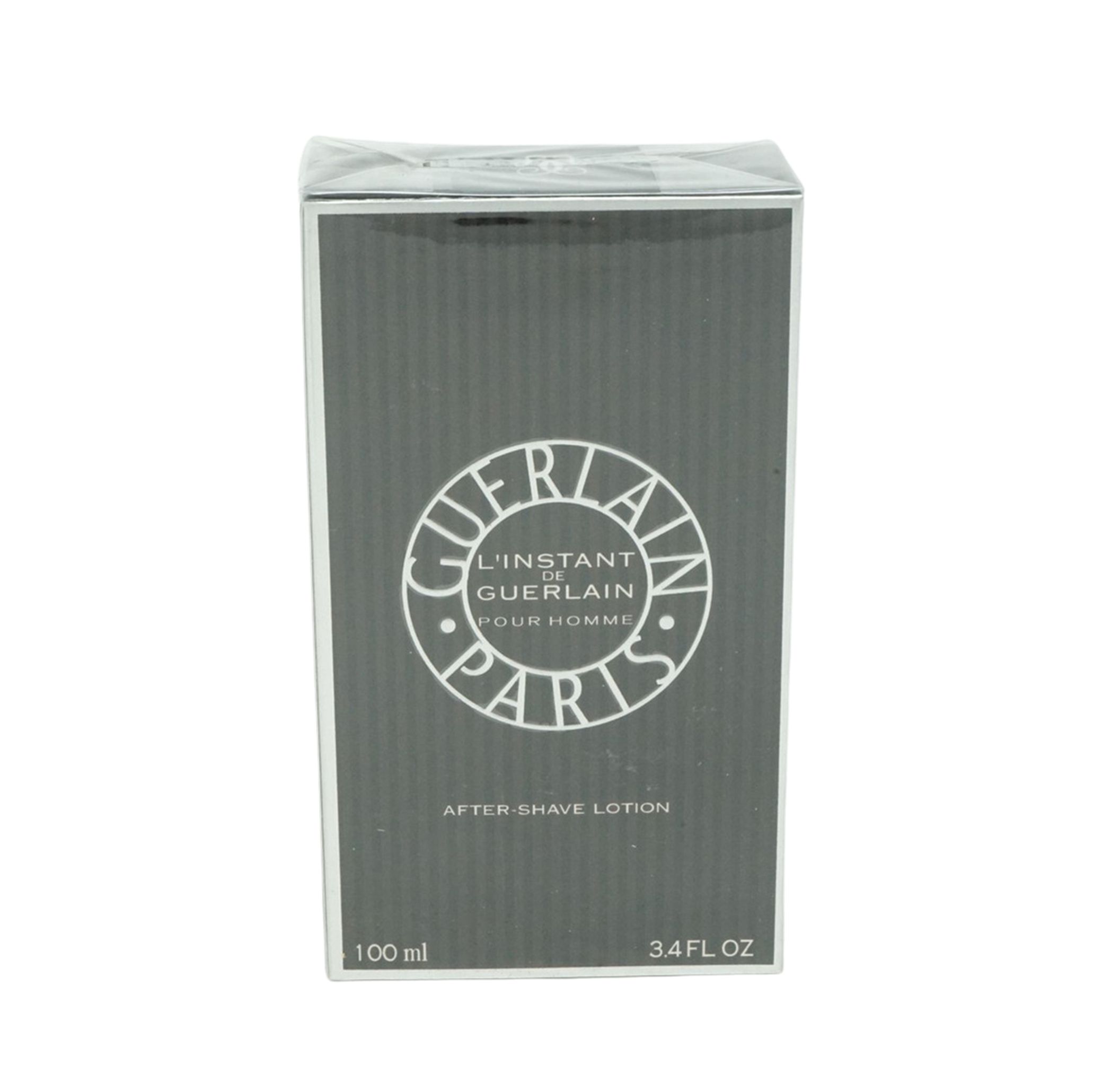 Graue Verpackung mit weißem Logo. Schriftzug: L'Instant de Guerlain Pour Homme Paris. Aufschrift: After-Shave Lotion. 100 ml, 3.4 FL OZ.